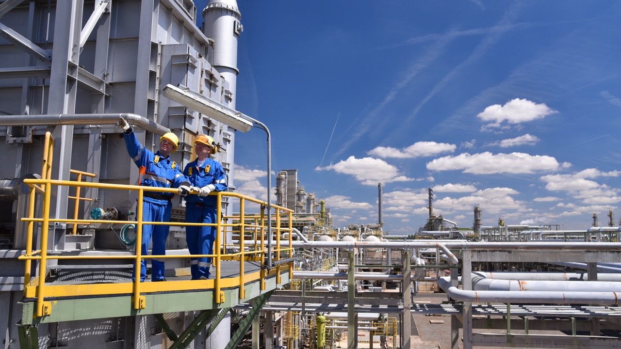 Group of industrial workers in a refinery